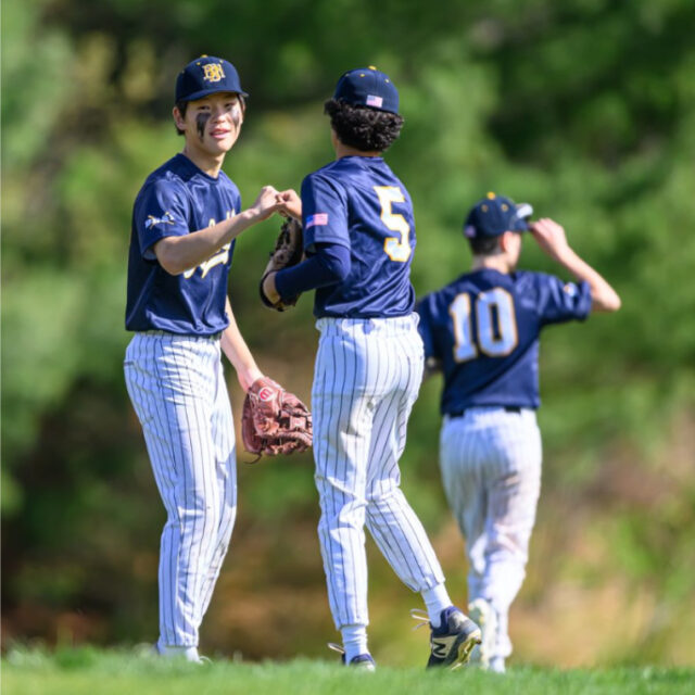 students on baseball team in game.