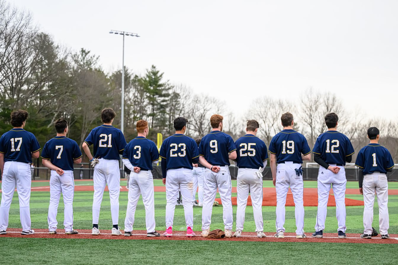 A group of baseball players standing on a field.