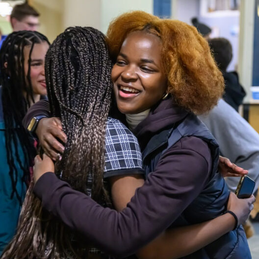 alumnae hugging.