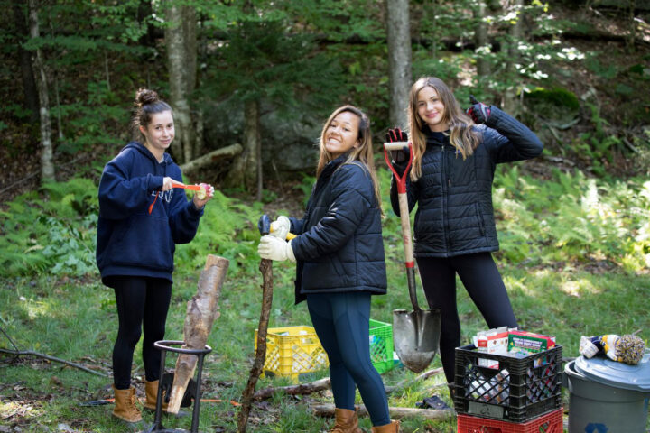 students digging in the woods.
