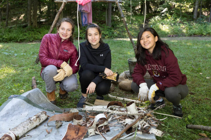 students building a camp fire.