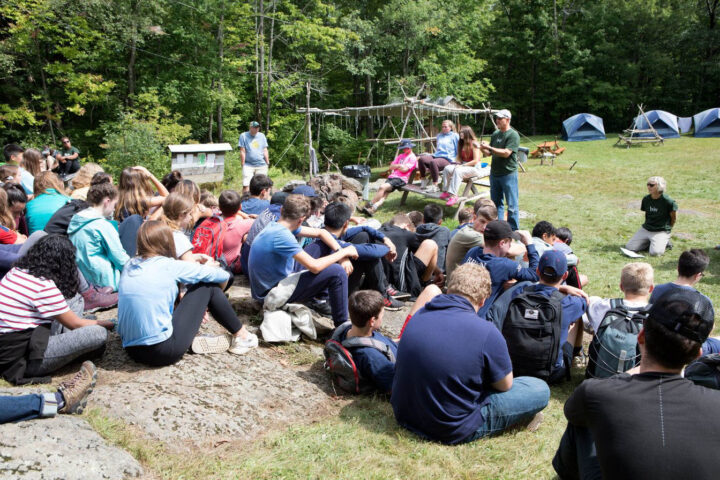 students listening to presentation outside.