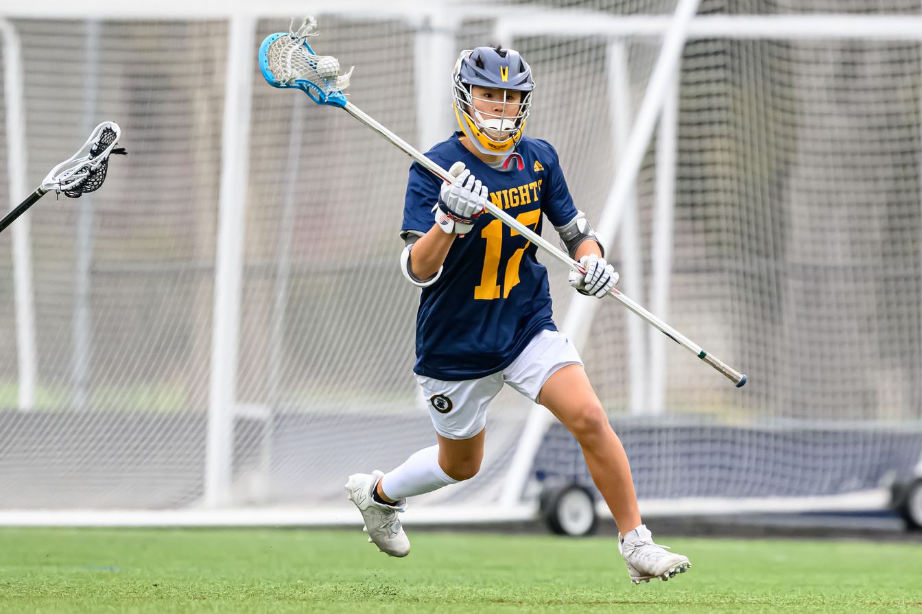 boy in lacrosse game.