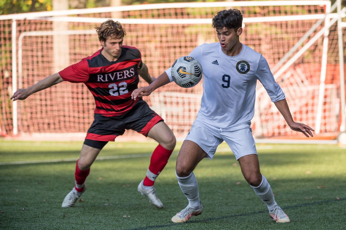 two boys in soccer game.