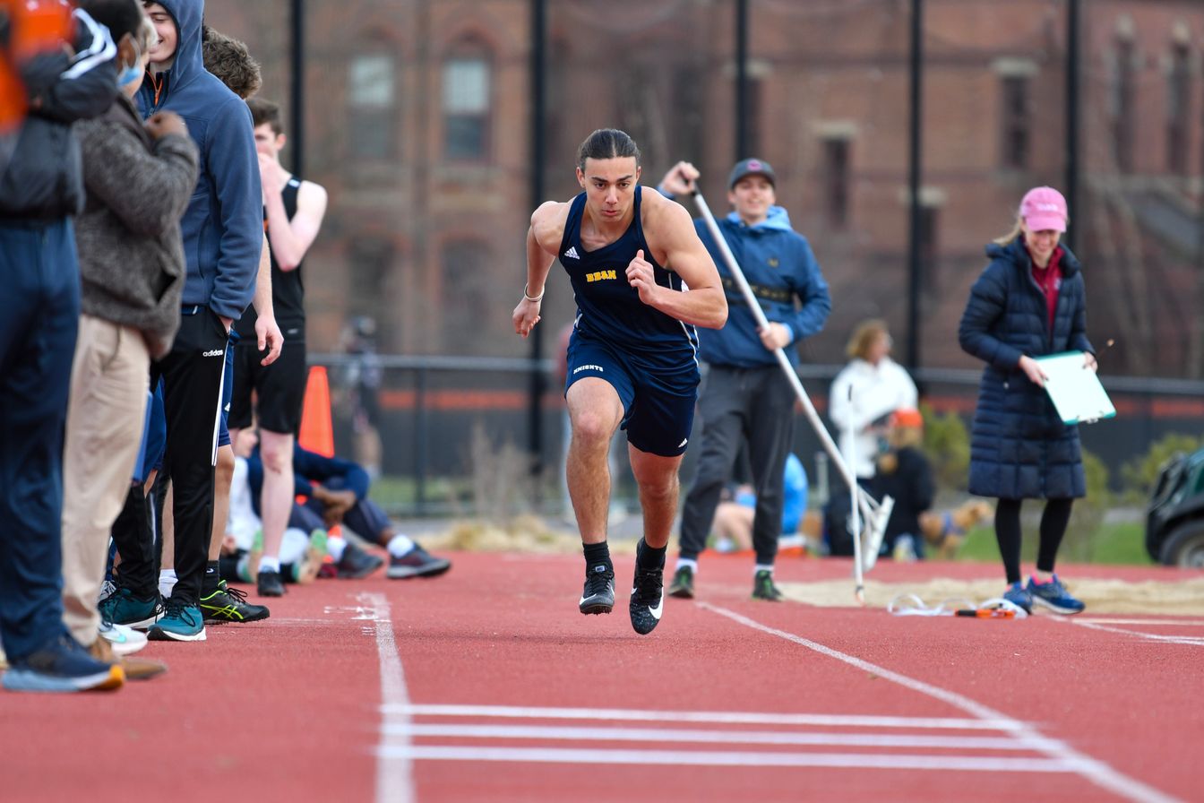 boy sprinting on track.
