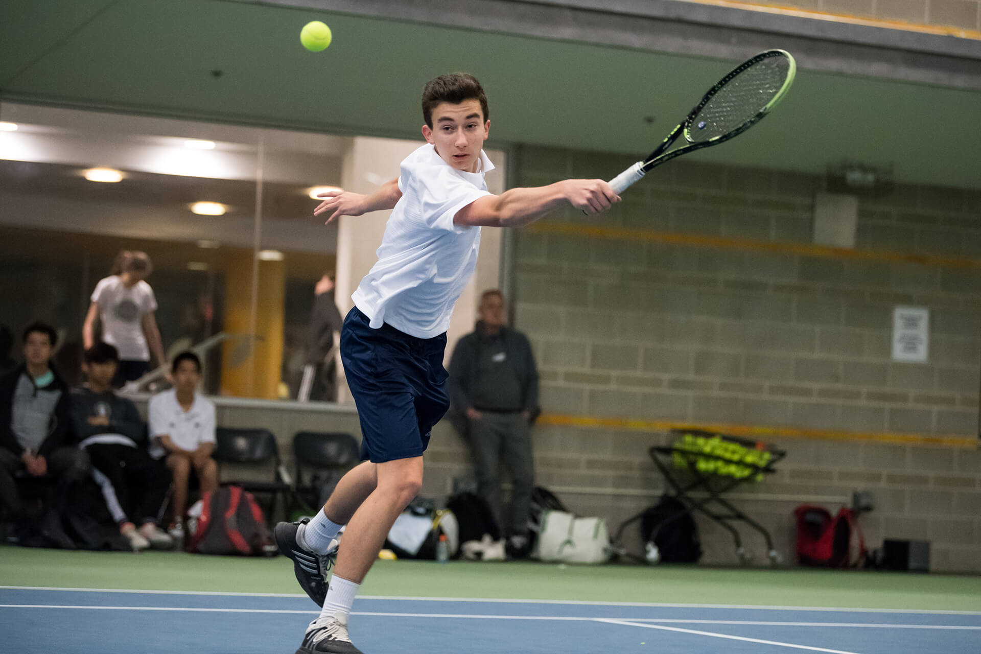 boy playing tennis.