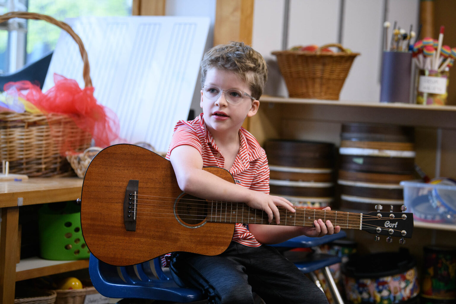 child holding guitar.