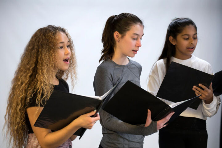 girls singing in choir.
