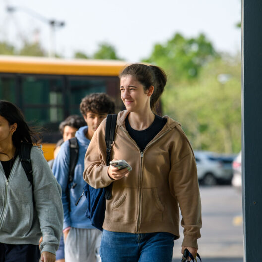 high school students walking into building.