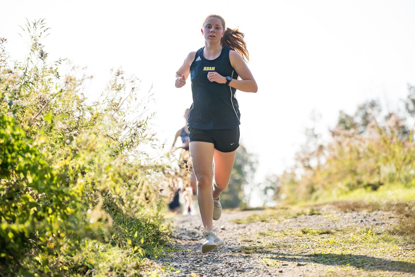 girls cross country runner running.