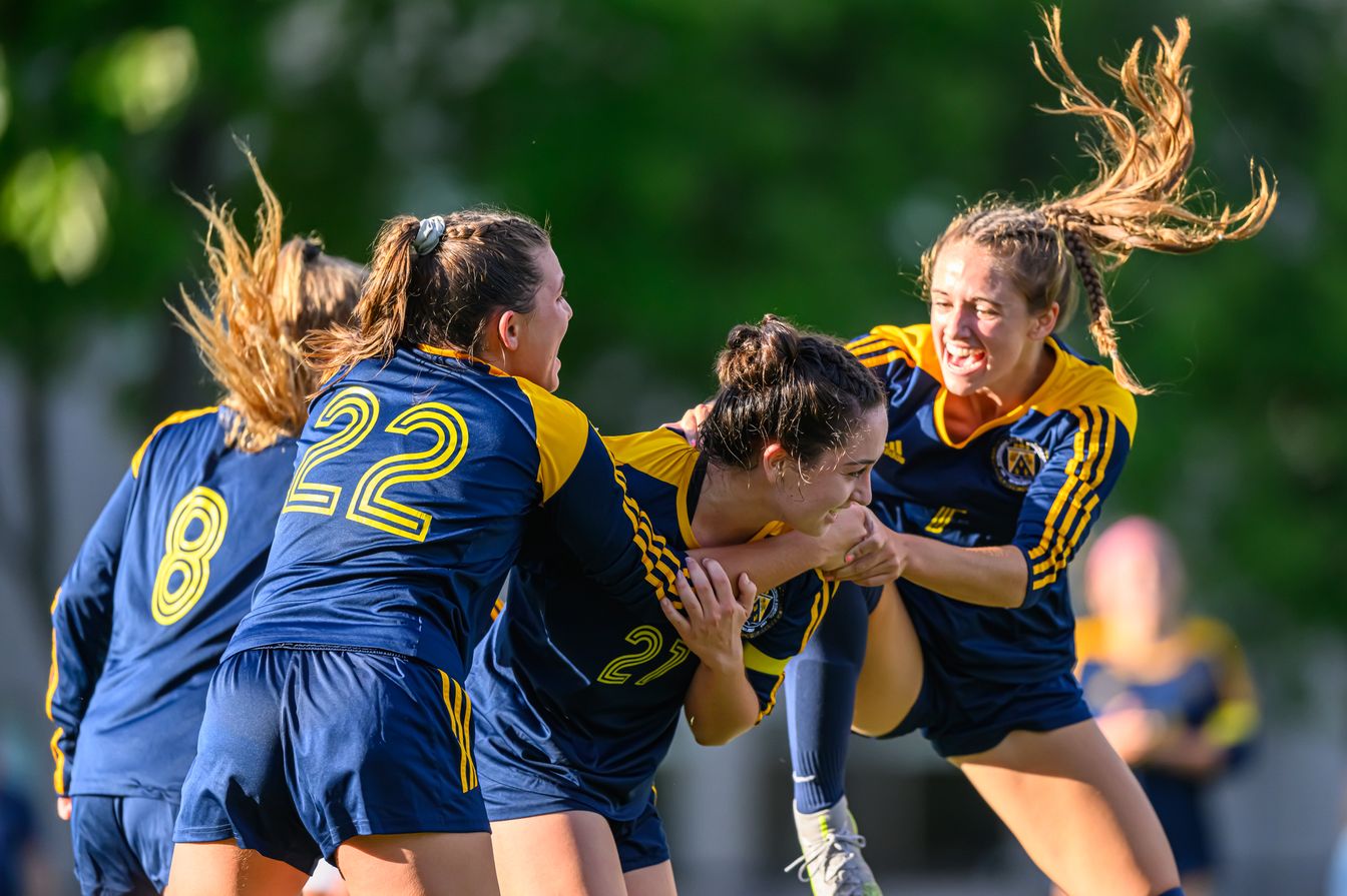 girls soccer team celebrating.