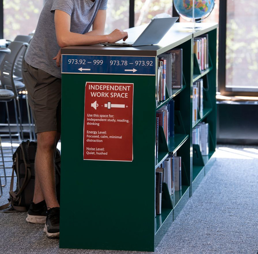 student working on laptop while standing.