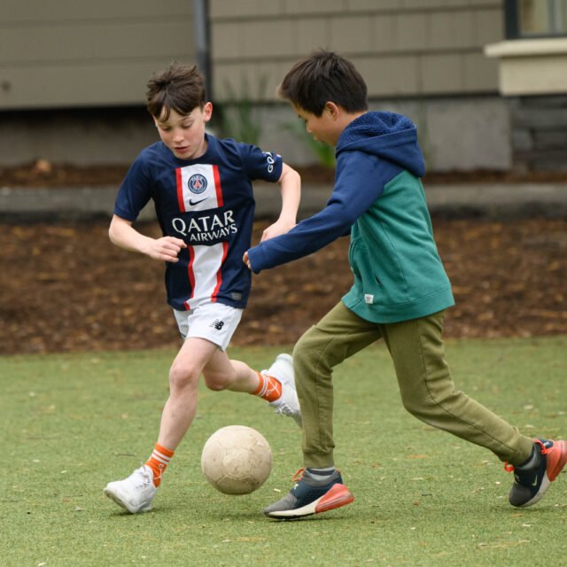 children playing soccer.