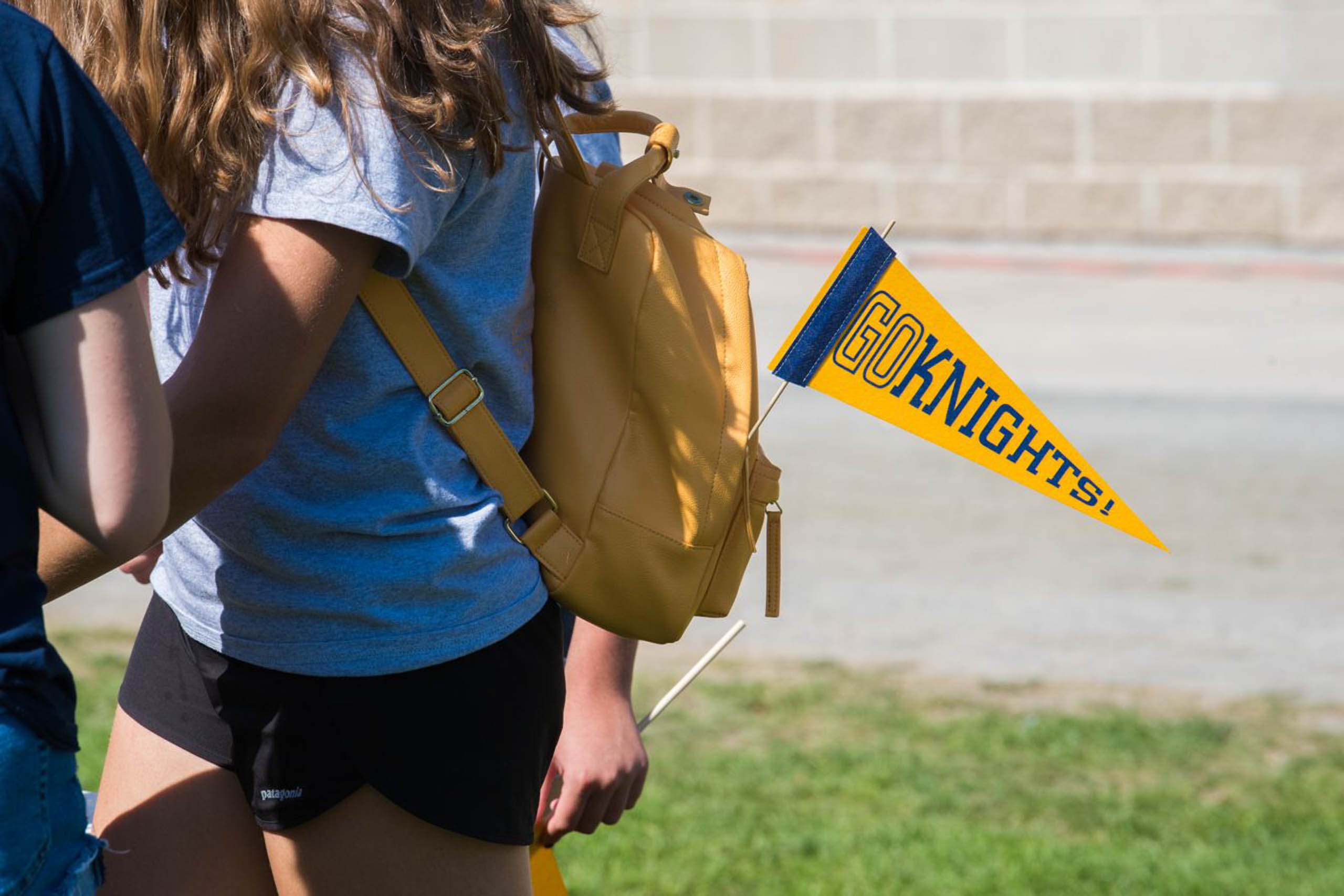 Go Knights flag out of a student's bookbag.