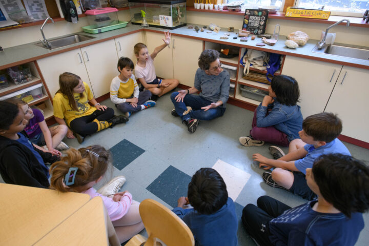 kids sitting on floor in science class.