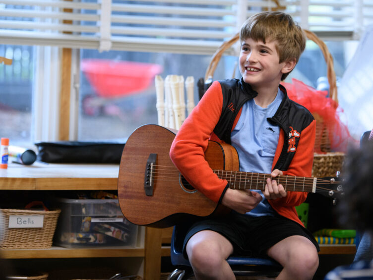 music student holding guitar.