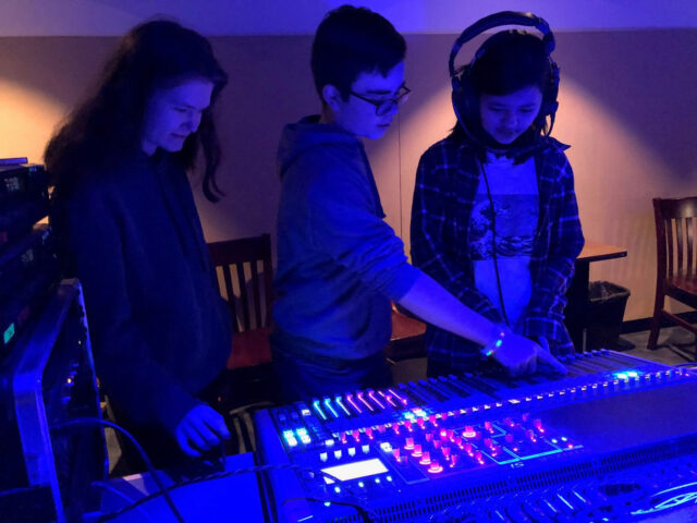 students behind sound board.