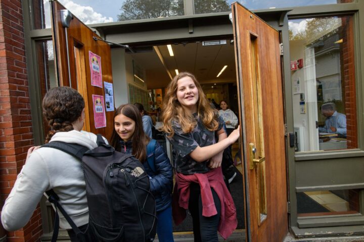 students opening door.