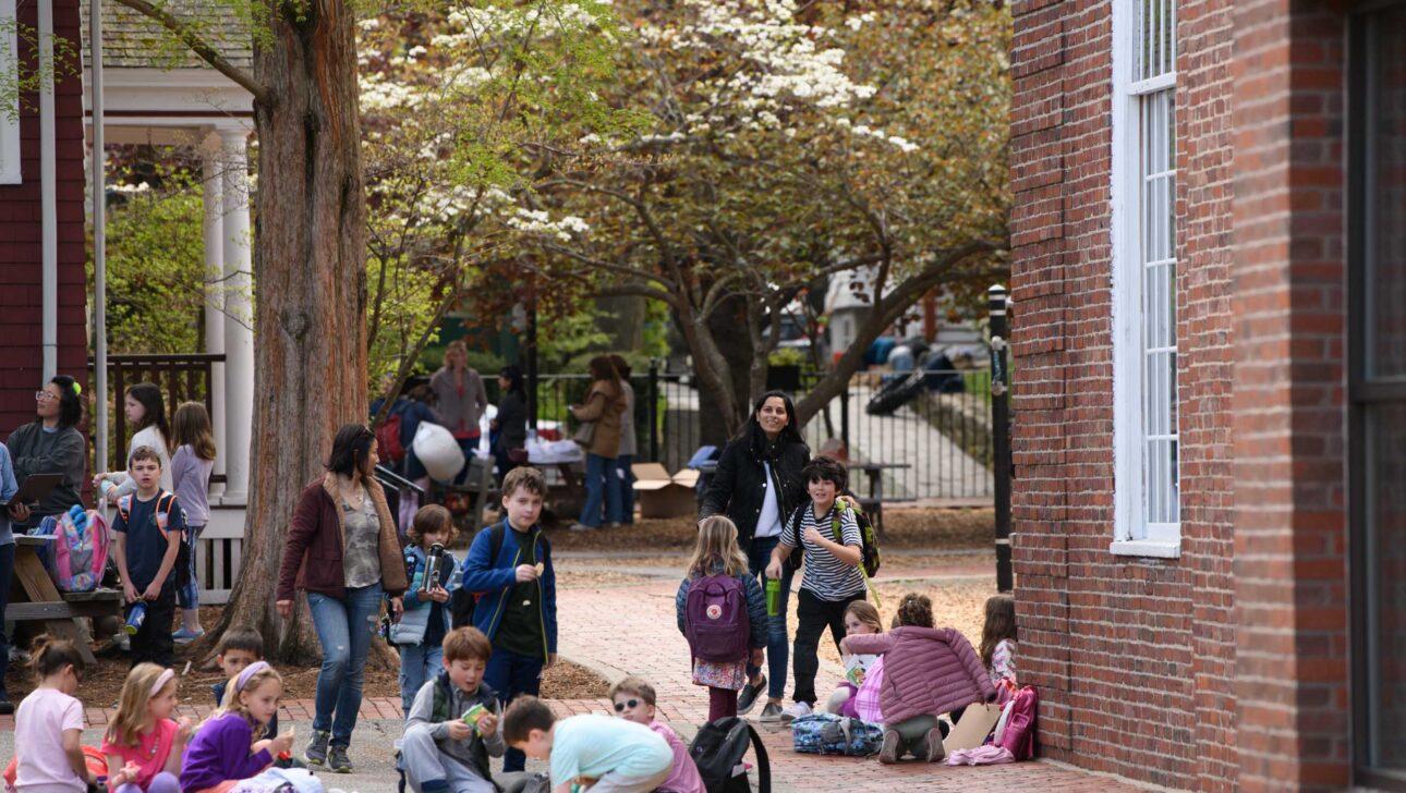 students sitting outside of school for pickup.