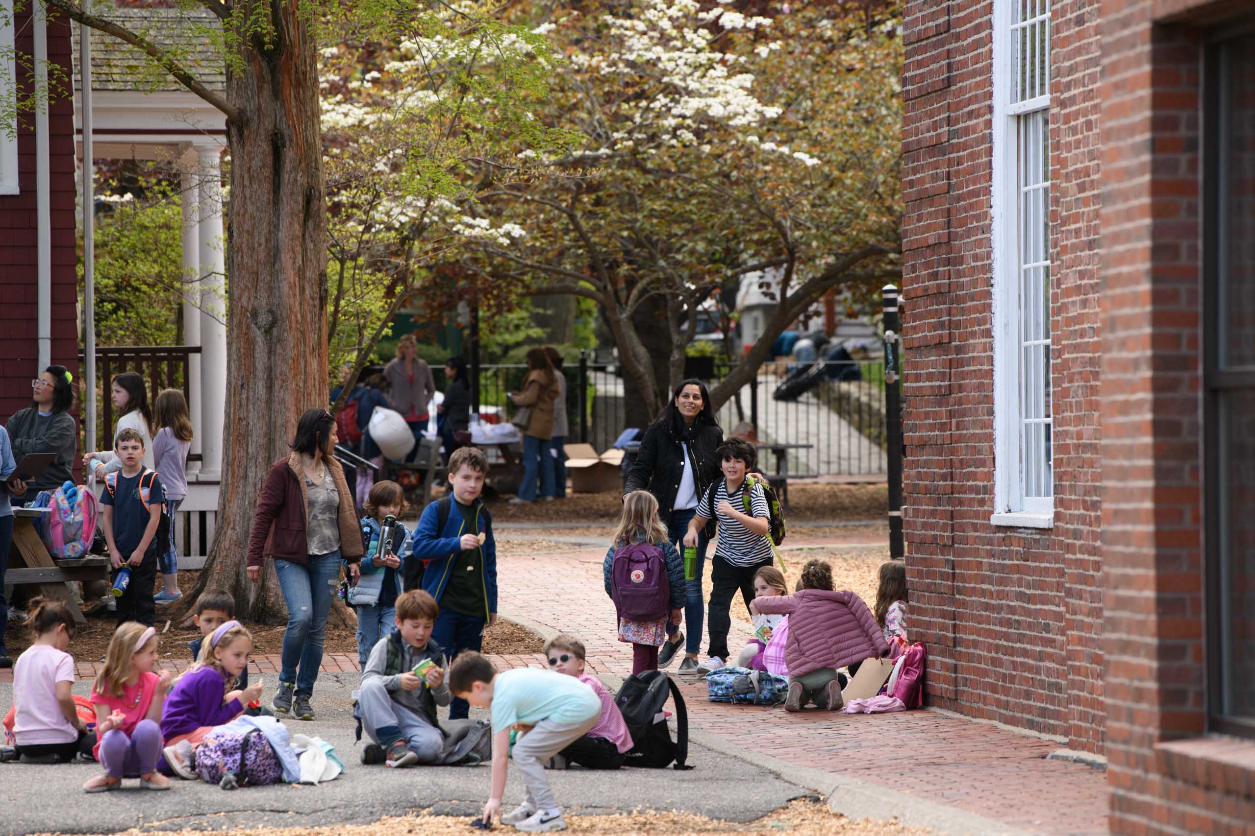 students sitting outside of school for pickup.