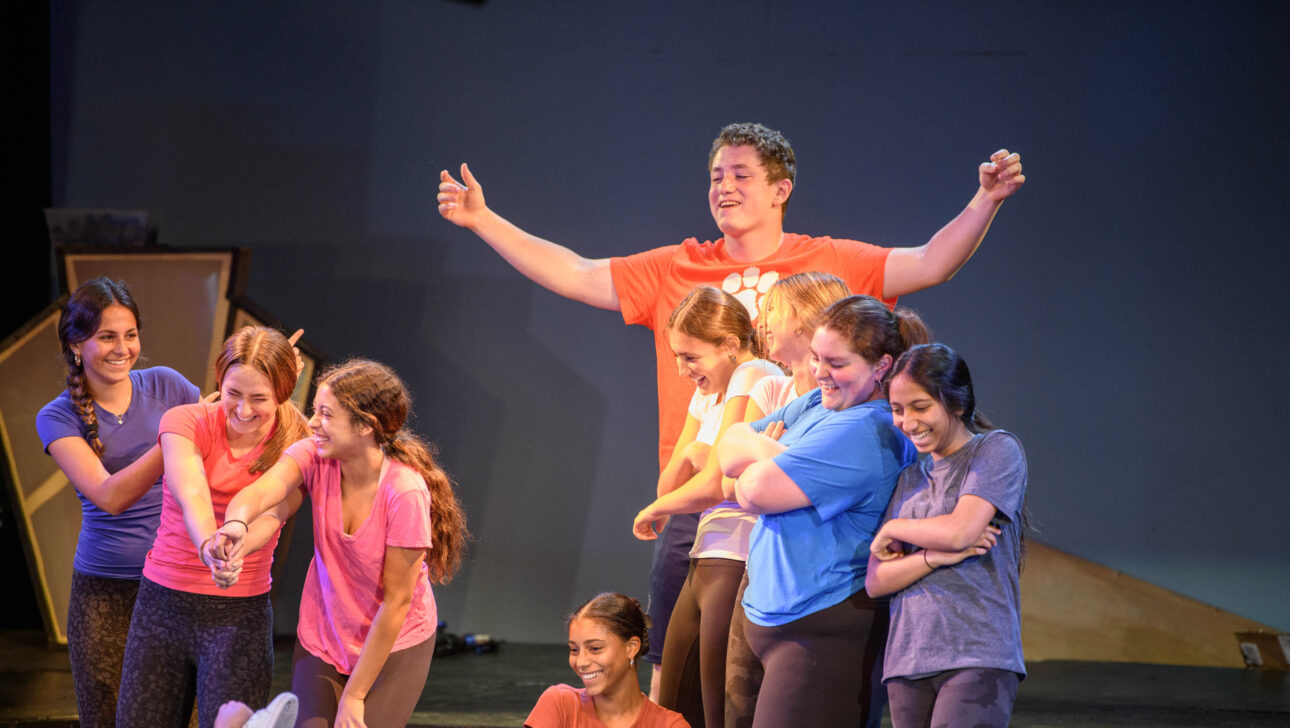 students performing on stage.