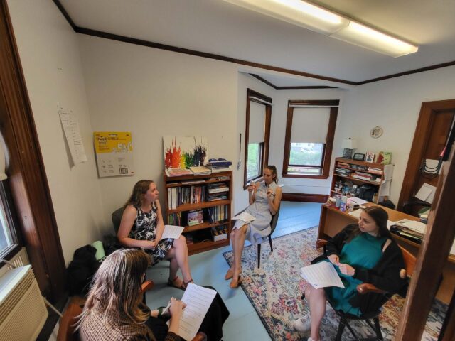 teachers discussing in office.