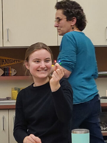 teacher in training holding leds.