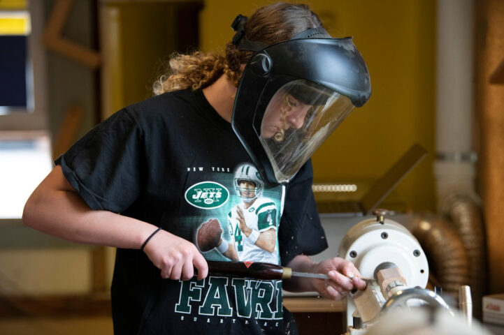 student turning wood.