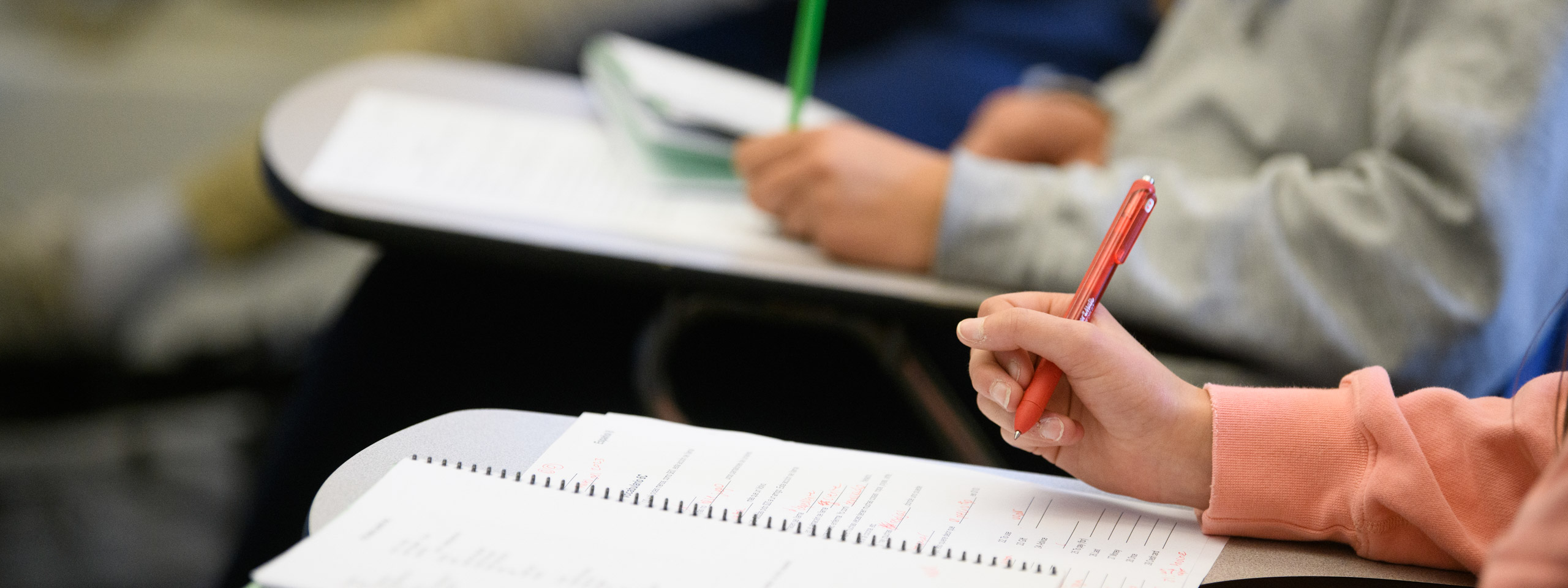 students writing in notebooks.