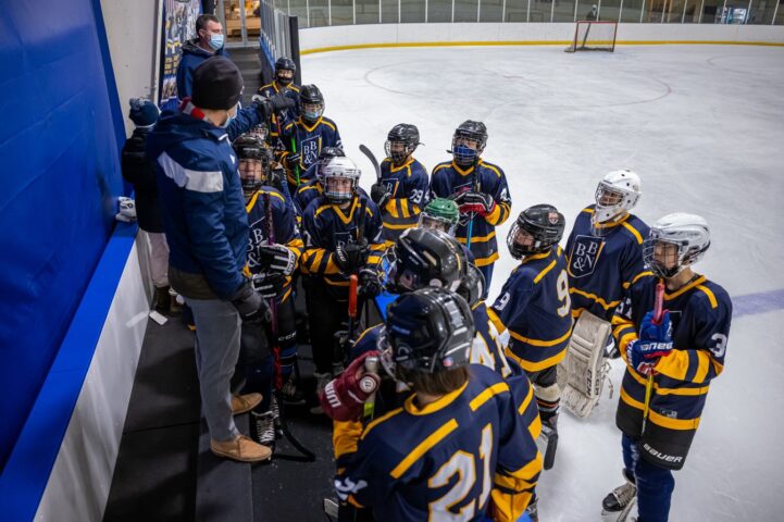 A group of hockey players standing in a rink.