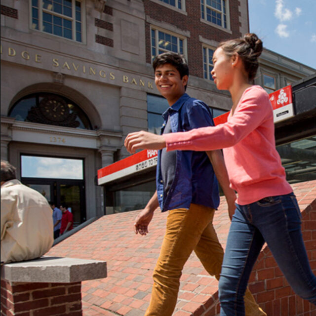 two students walking in harvard square.